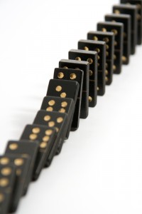 bigstock-Black-Dominoes-Falling-Down-In-1081634